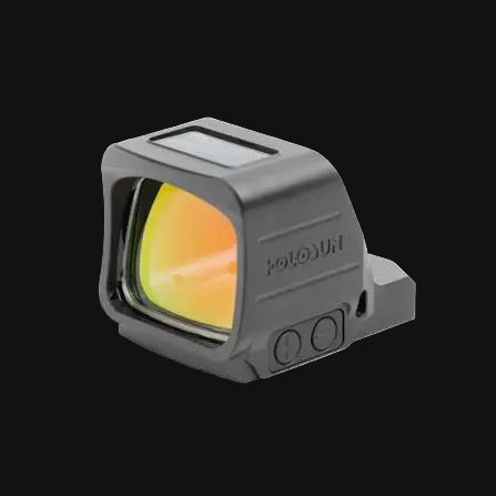 Holosun red dot sight angled view, dark gray body with yellow-green illuminated window