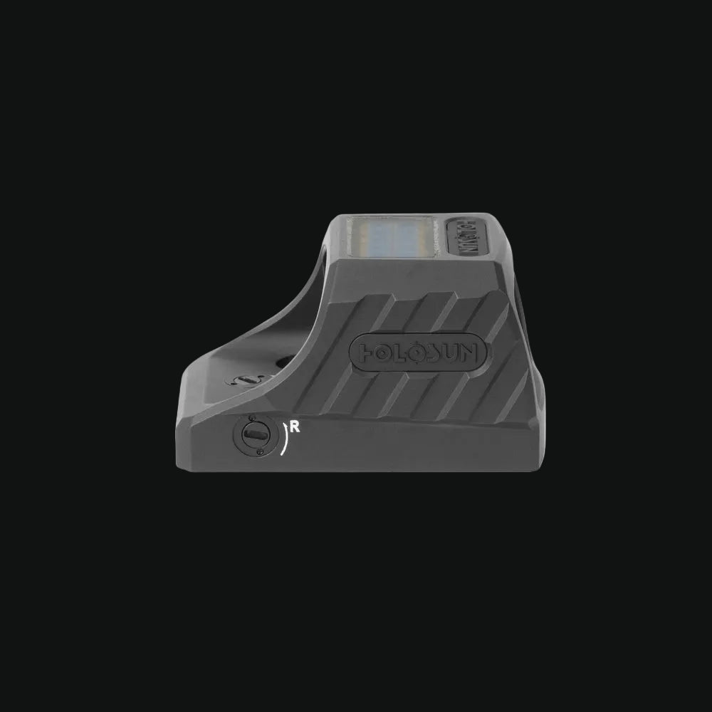 Gray pistol reflex sight with circle-dot reticle window, side controls visible