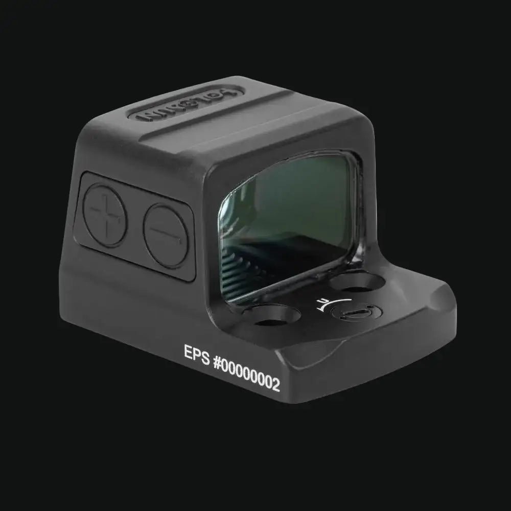 Enclosed reflex dot sight with tinted green window and side control buttons, gray body