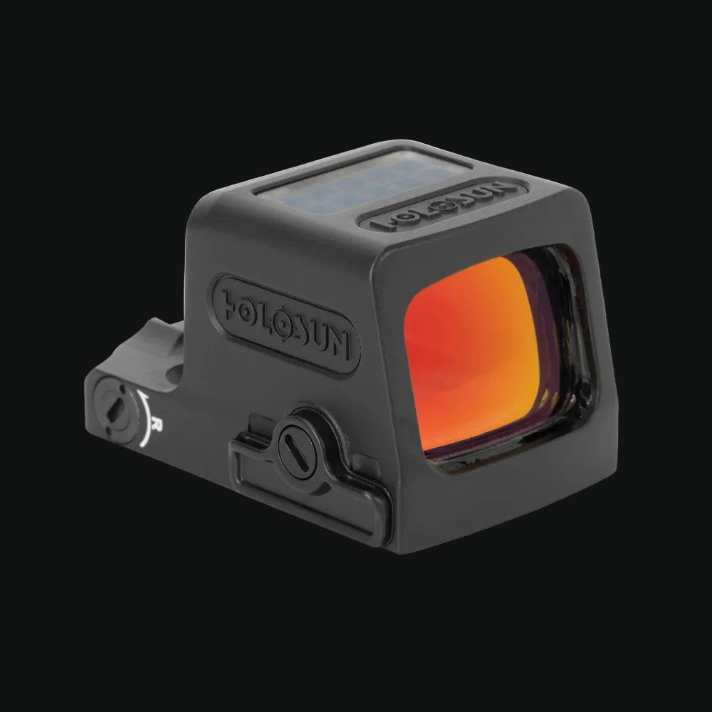Enclosed solar reflex red-dot sight with orange-tinted lens window and dark housing