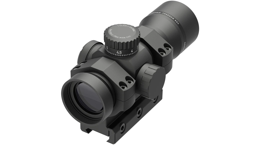 Black red dot scope with rail mount and adjustment knobs, angled side view