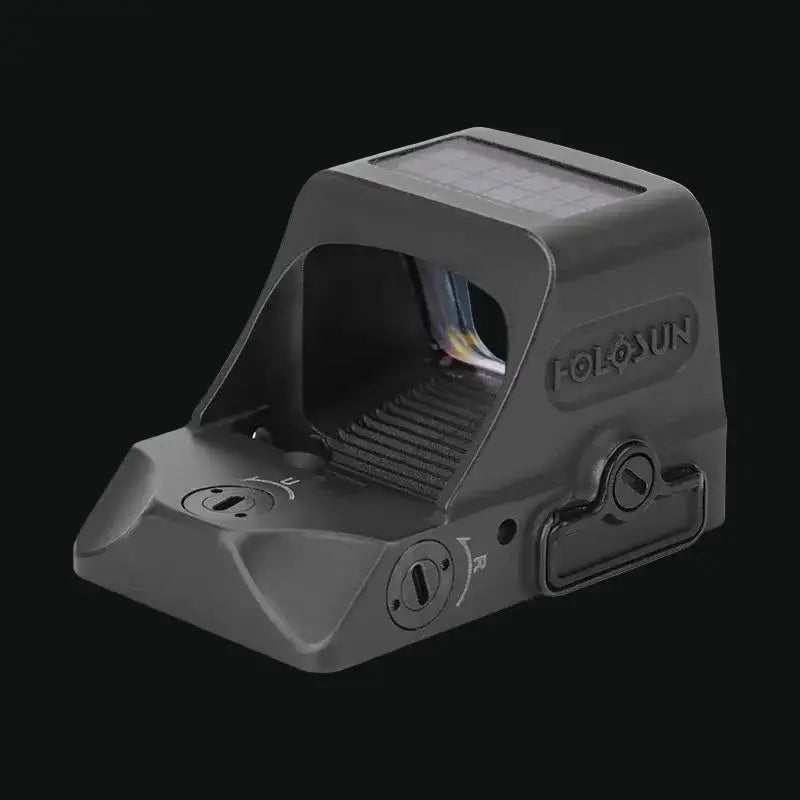 Holosun reflex red dot sight, side view with solar panel, control knobs on black body