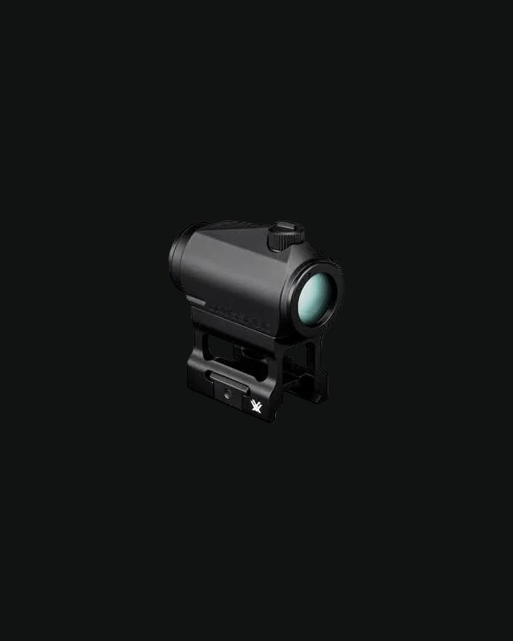 Red dot sight with mount, black body and front lens, side view