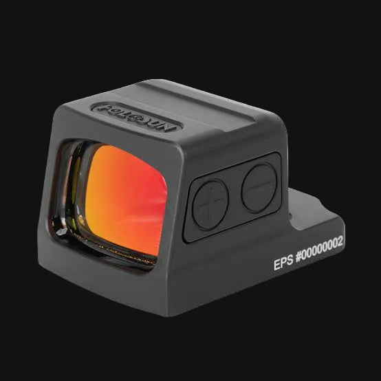 Enclosed red dot sight with orange lens window and side control buttons.