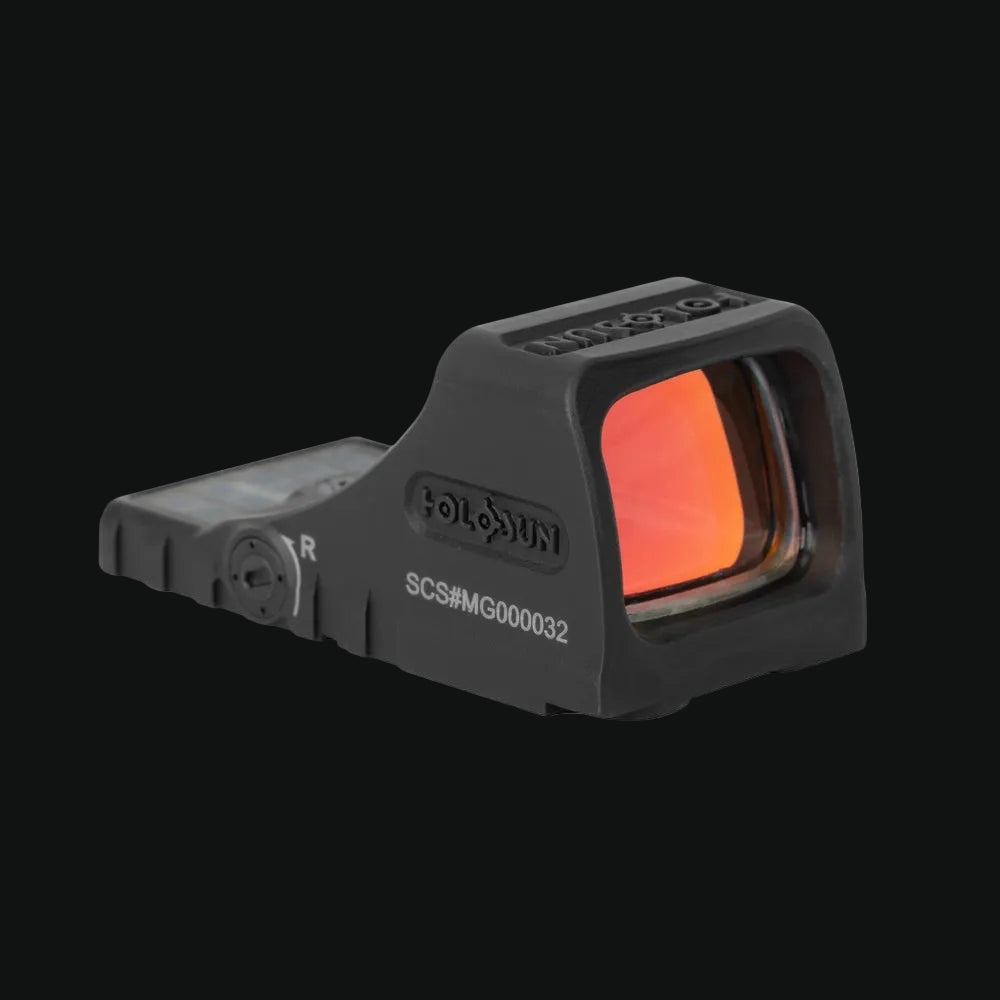 Black reflex sight with illuminated lens window and 'R' marking on side