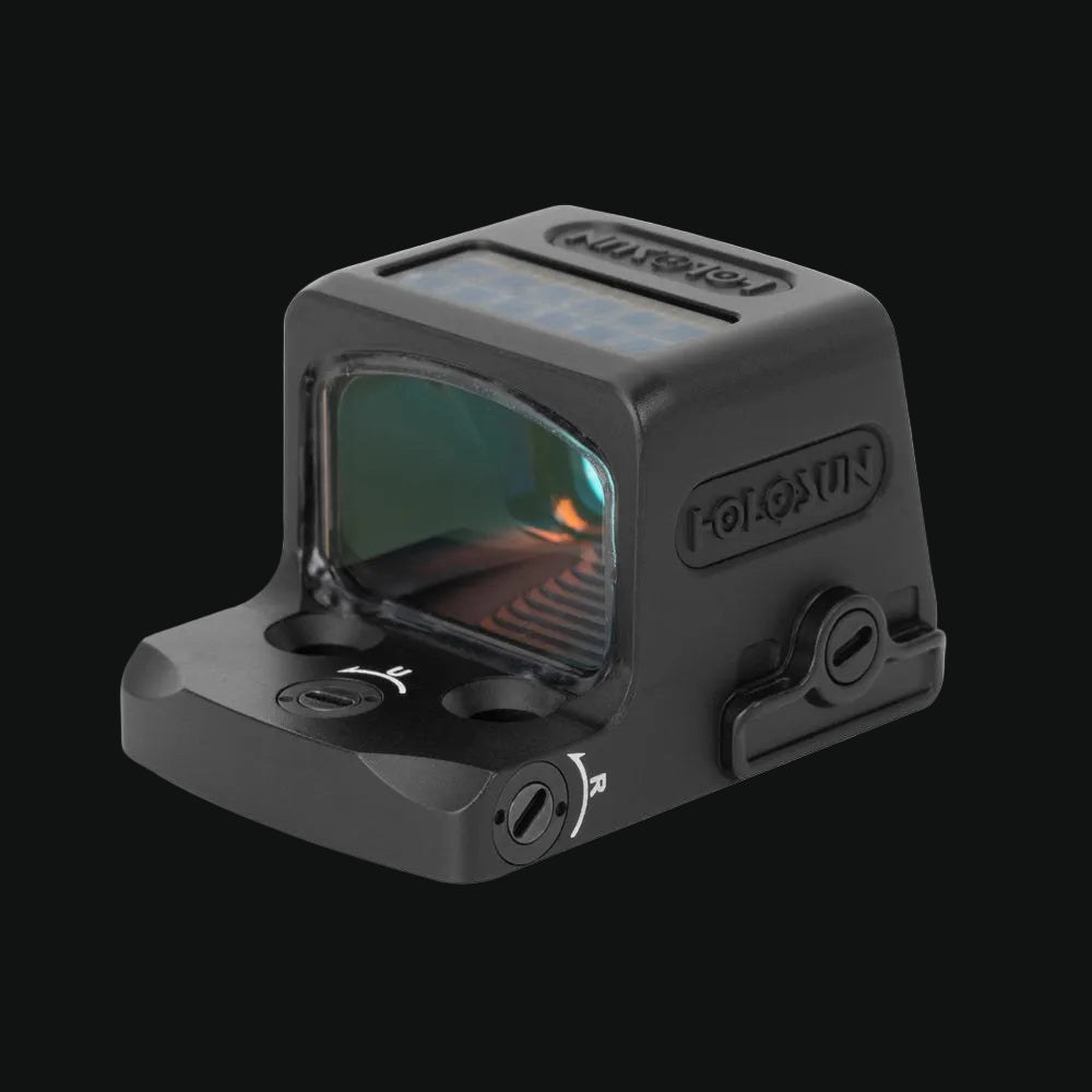 Holosun enclosed red dot sight in side view with window showing green reflection