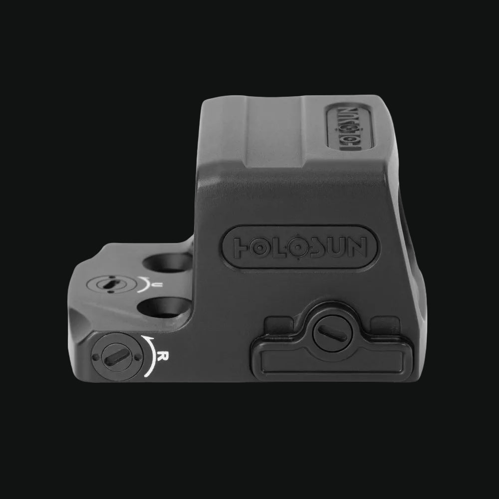 Enclosed red dot sight side profile with adjustment knobs and rail
