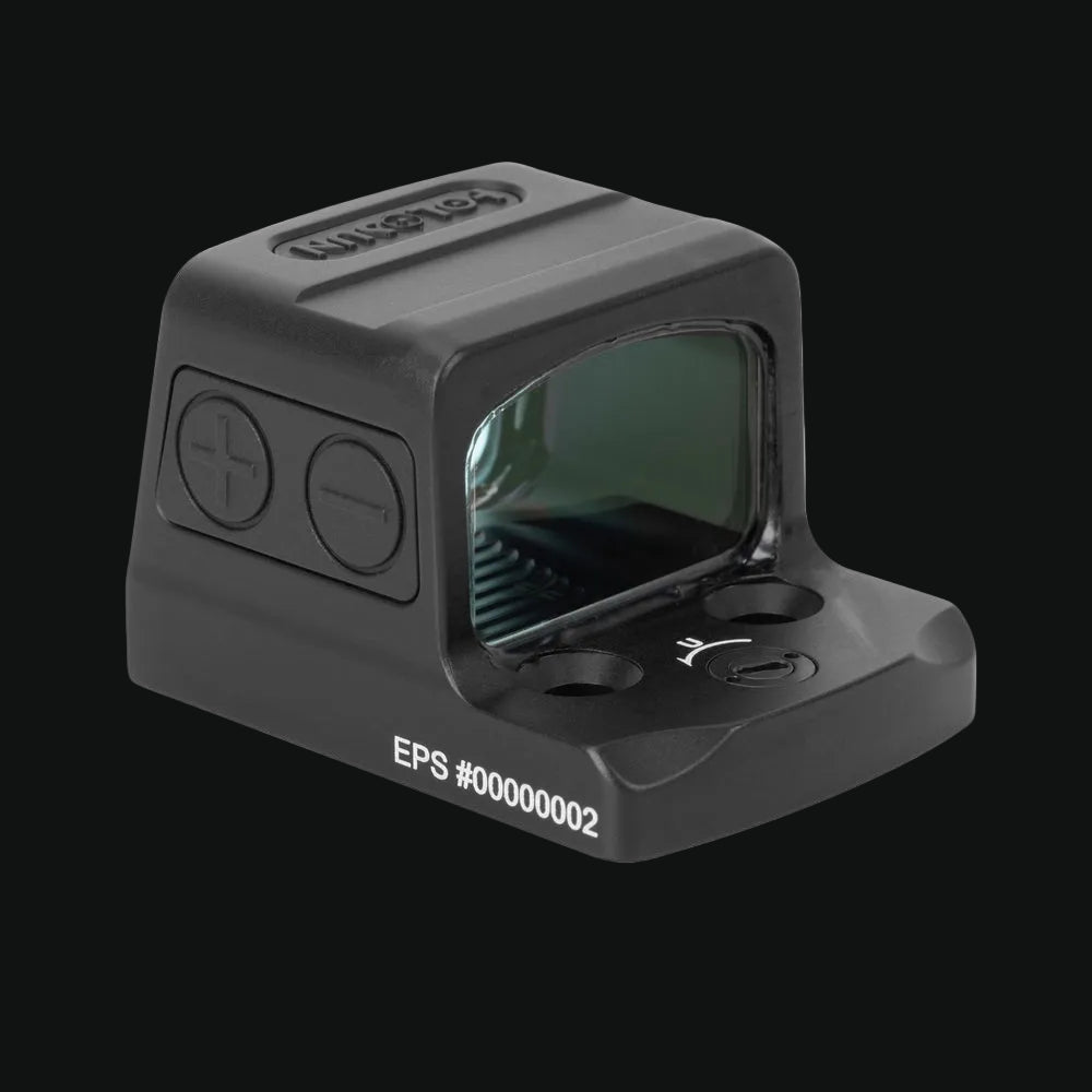 Enclosed reflex dot sight with tinted green window and side control buttons, gray body