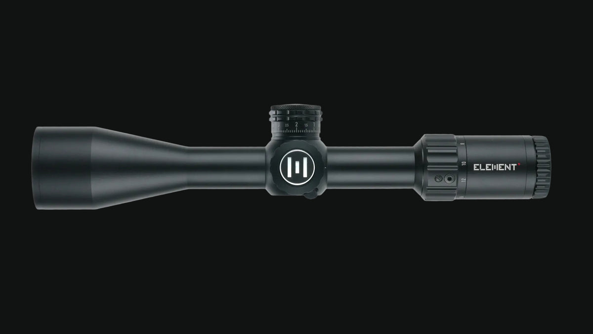 Matte black riflescope with objective bell and adjustable turrets, compact profile.
