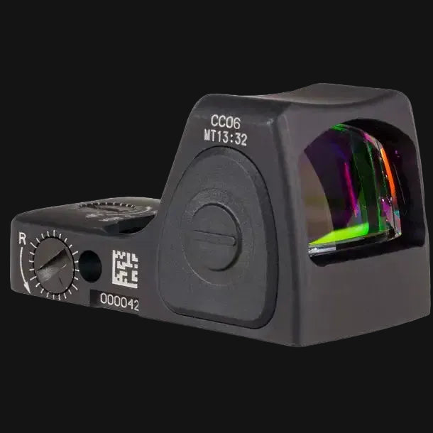Black red dot sight with colored lens reflections and side R dial visible.