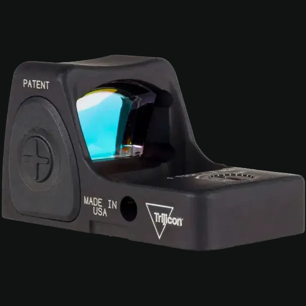 Black Trijicon red dot optic showing MADE IN USA and illuminated lens window.