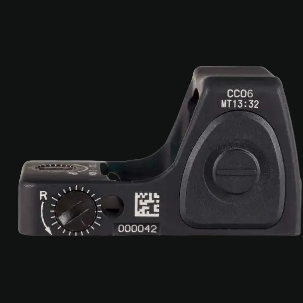 Compact red dot sight with adjustable dial and QR marking, black housing.