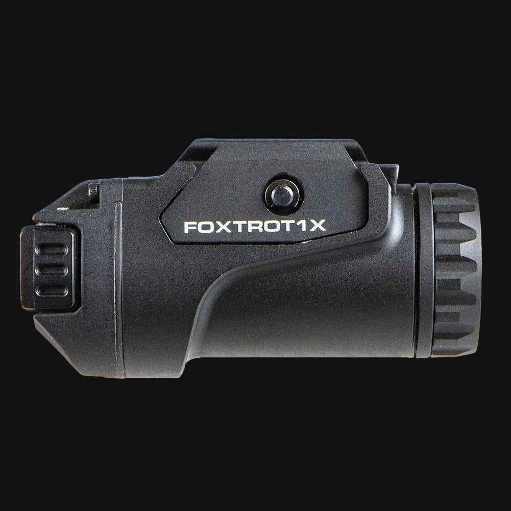 Weapon-mounted tactical light with FOXTROTX label and front lens bezel